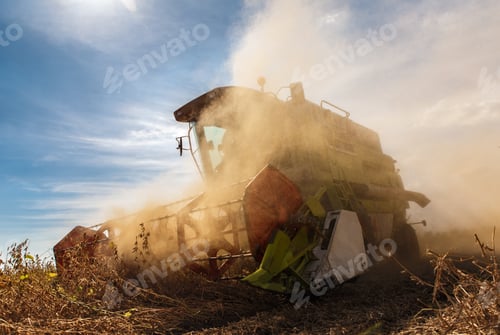 Preview: Harvester machine working in field harvesting soybean corp.