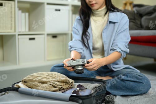 Preview: Woman Prepares Camera and Luggage for Travel