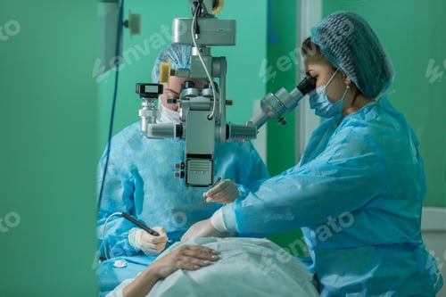 Preview: a young woman ophthalmologist performs an operation on the patient's eye