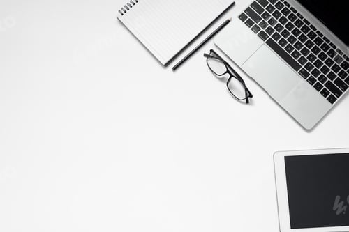 Preview: White office desk. table with blank notebook, tablet, glasses, calculator, computer and other office