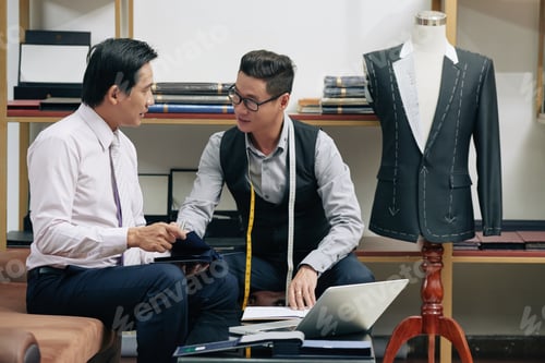 Preview: Men Discussing Custom Suit in Tailor Shop