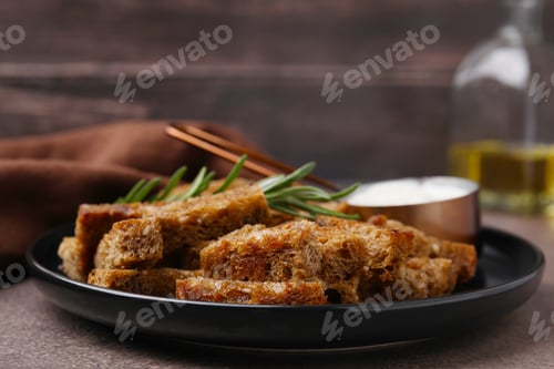 Preview: Crispy rusks with rosemary and sauce on grey table