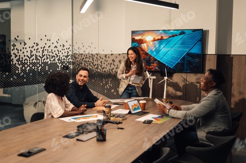 Preview: Innovative businesswoman presenting solar panels model to diverse experts