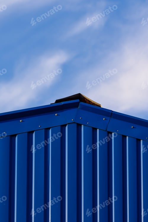 Preview: Vertical low angle shot of a modern building with blue metal facade