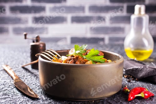 Preview: stew in tomato sauce with vegetables in gray bowl