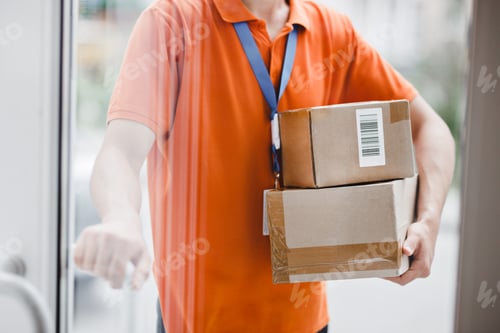 Preview: A person wearing an orange T-shirt and a name tag is standing behind the glass door and holding a