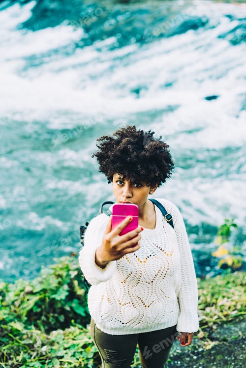 Woman Takes Selfie Near a Flowing River