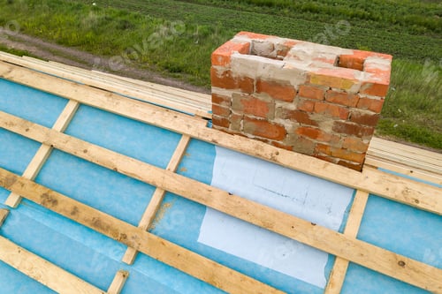 Preview: Aerial view of a wooden roof frame of brick house under construction