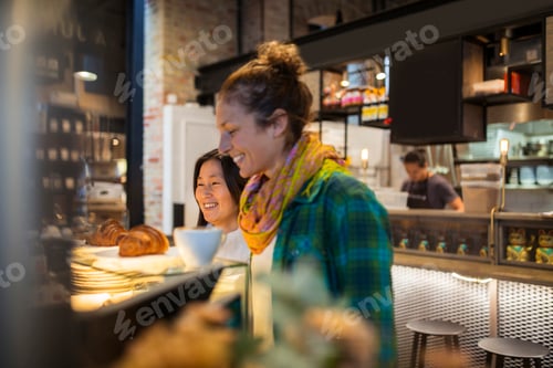 Preview: Two women eating breakfast in supermarket