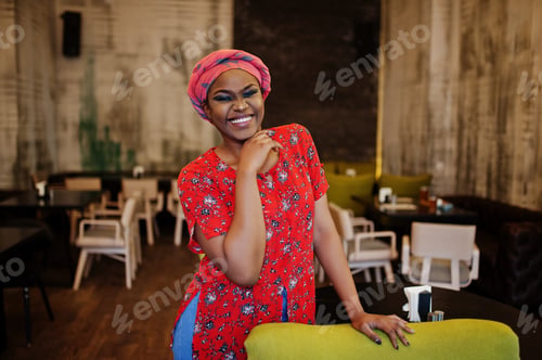 Preview: Stylish african woman in red shirt and hat