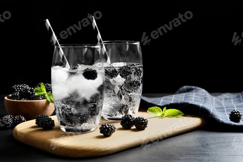 Preview: Delicious refreshing blackberry lemonade on table against dark background. Space for text