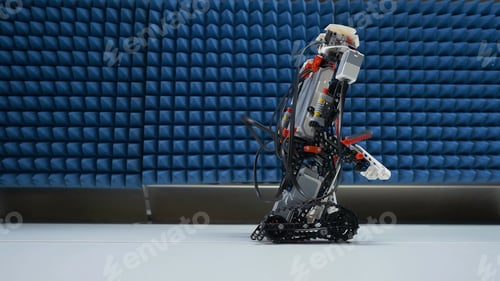 Preview: Small hunan-like robot sited on the table. Modern robot goes on the table close up