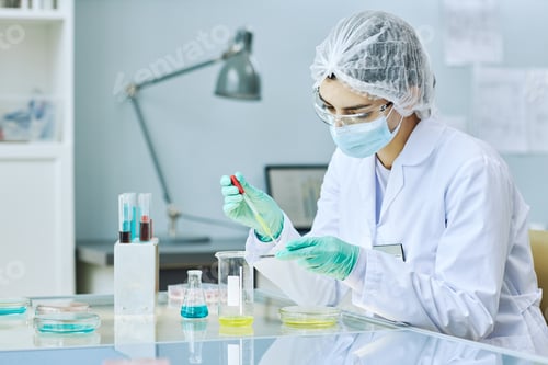 Preview: young woman working in laboratory doing experiments in petri dish