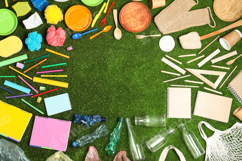 Preview: Flat lay composition with household goods on green grass, space for text. Recycling concept