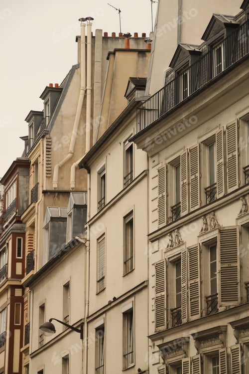 Preview: Parisian architectural charm with ornate windows and chimneys.