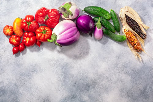 Preview: Fresh select seasonal vegetables atop grey textured backdrop, top view, copy space