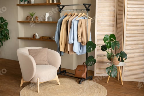 Preview: Trendy capsule wardrobe in beige and light blue on a rail rack