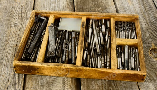 Preview: box with drills on a wooden background.