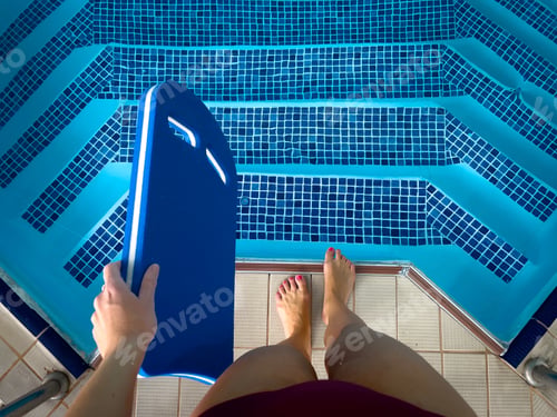 Preview: Woman standing near the pool preparing for a swim
