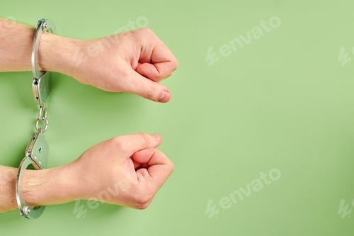 Preview: Hands in handcuffs, copy space.