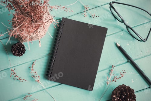 Preview: Dry flower with blank notebook on old wooden table