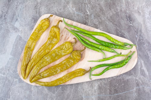Preview: Fresh and fermented peppers on wooden board