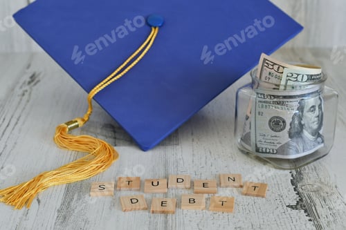 Preview: Graduation cap mortarboard with tassel propped on a jar of money cash, words STUDENT DEBT
