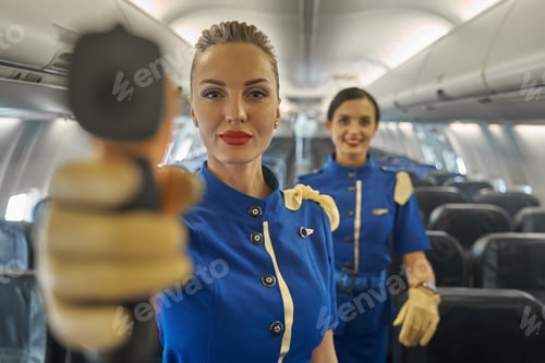 Preview: Confident stewardess conducting temperature screening at work