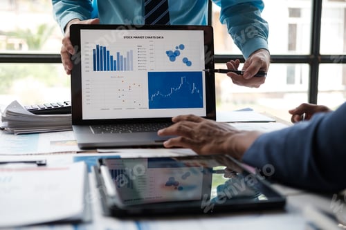 Preview: Asian business advisor meeting to analyze and discuss the situation on the financial report in the m