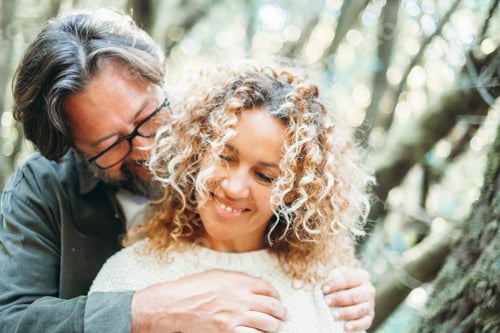 Preview: Love and romance in outdoor leisure activity with man and woman in love hugging and bonding outdoors