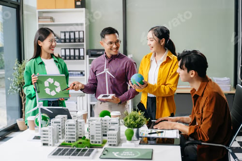 Preview: Group of diverse multiethnic businesspeople standing neare table looking at model of building from