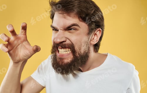 Preview: Man in white t-shirt cropped view of emotions beard yellow background