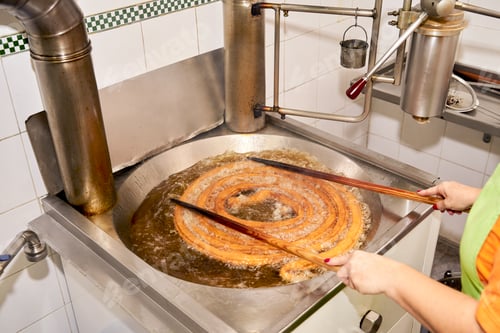 Preview: Cook preparing typical Spanish breakfast with dough.