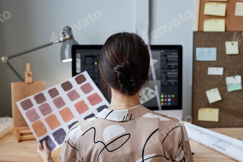 Preview: Female designer holding color swatches at workplace
