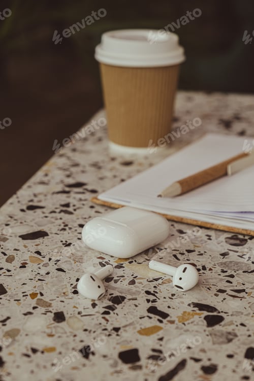 Preview: Take away coffee in craft recycling paper cup with paper notebook with wireless headphones. Mockup