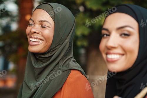 Preview: Multiracial muslim women laughing while walking together