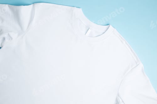 Preview: Basic folded white t-shirt blue background. Mock up for branding t-shirt. Copy space