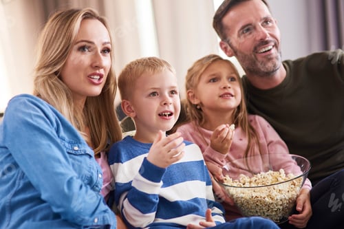 Preview: Family with two children spending time together in living room