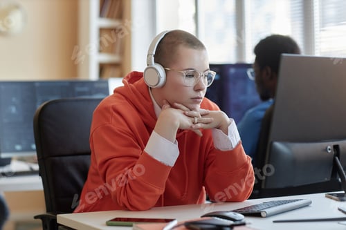 Preview: Young IT support manager or cyber security engineer in headphones