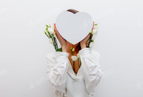 Preview: woman with white roses holding a heart shape gift box.