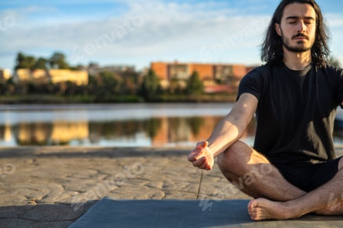 Preview: Man practicing yoga meditation for inner harmony outdoors