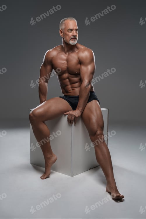 Preview: Handsome, toned male model with a stylish gray beard