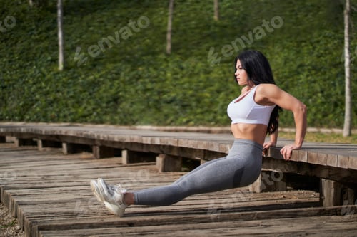 Preview: Slim woman doing yoga in park