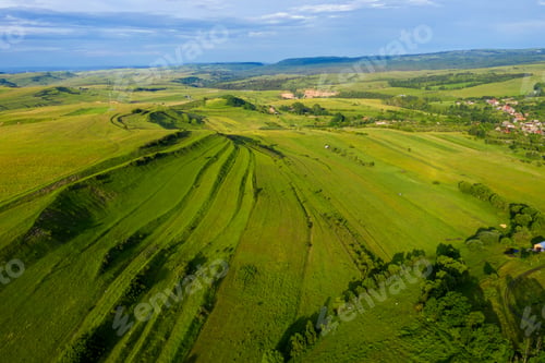 Preview: Aerial view of countryside vibrant green hills. Transylvania, Romania, drone point of view