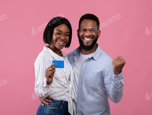 Preview: Portrait of millennial black couple with credit card gesturing YES, recommending bank services on