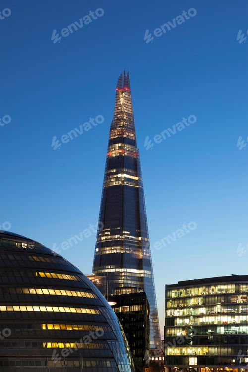 Preview: Lit skyscrapers against blue sky
