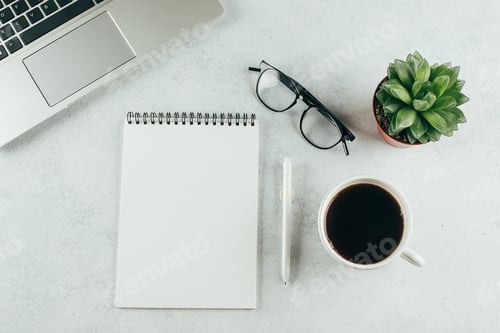 Preview: Modern office desk table with laptop, empty notebook, cup of coffee, succulent and eyeglasses
