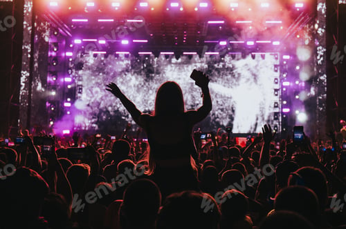 Preview: Girl in a audience crowd having fun and enjoying concert on a festival