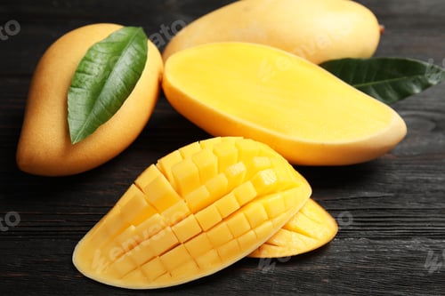 Preview: Ripe juicy mango on dark wooden table
