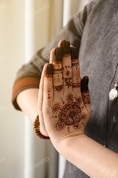 Preview: Woman with henna tattoo on hand, closeup. Traditional mehndi ornament